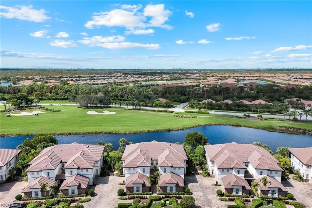 9525 Ironstone Terrace, Unit 102 Naples, FL 34120 - Photo 2 of 35 an aerial view of a house with a garden and lake view