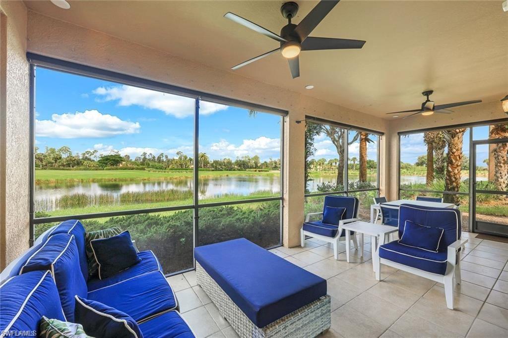 9525 Ironstone Terrace, Unit 102 Naples, FL 34120 - Photo 21 of 35 a living room with furniture and a floor to ceiling window