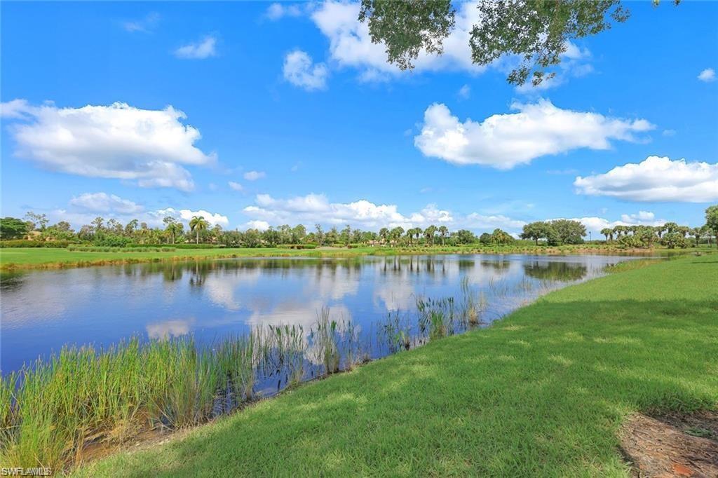 9525 Ironstone Terrace, Unit 102 Naples, FL 34120 - Photo 24 of 35 a view of a lake with a yard
