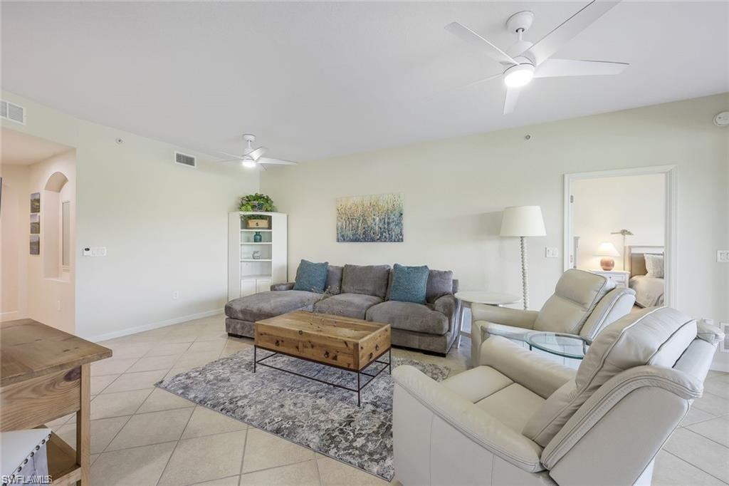 9525 Ironstone Terrace, Unit 102 Naples, FL 34120 - Photo 4 of 35 a living room with furniture and a couch
