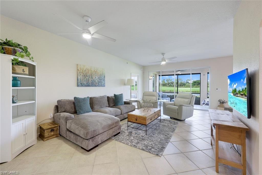 9525 Ironstone Terrace, Unit 102 Naples, FL 34120 - Photo 5 of 35 a living room with furniture and a flat screen tv