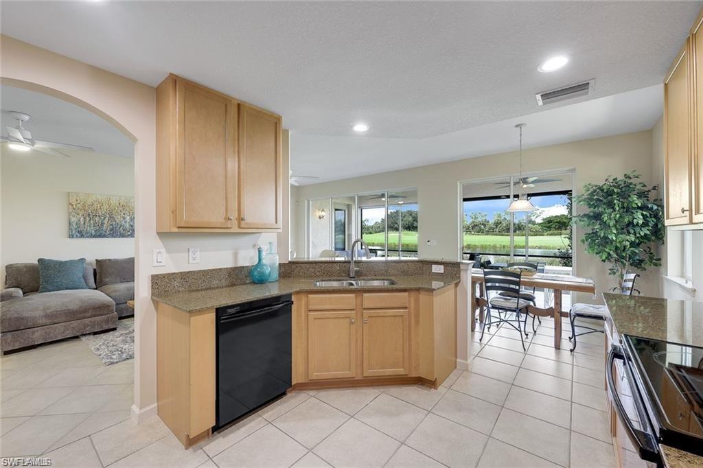 9525 Ironstone Terrace, Unit 102 Naples, FL 34120 - Photo 6 of 35 a kitchen with a sink and cabinets