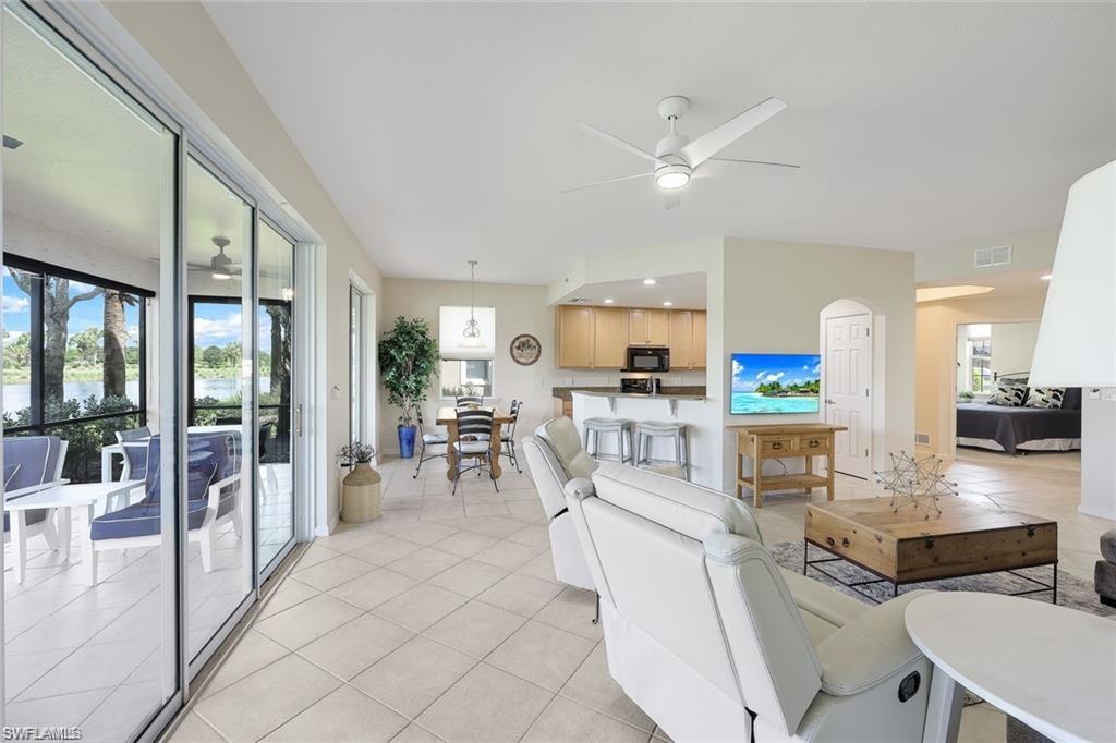 9525 Ironstone Terrace, Unit 102 Naples, FL 34120 - Photo 7 of 35 a view of a dining room with furniture water view and kitchen view