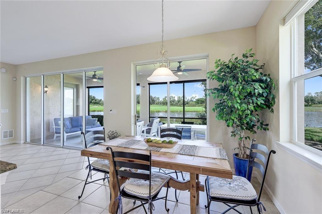 9525 Ironstone Terrace, Unit 102 Naples, FL 34120 - Photo 8 of 35 a dining room with furniture window and wooden floor