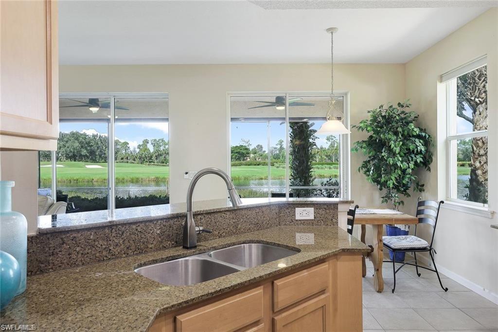 9525 Ironstone Terrace, Unit 102 Naples, FL 34120 - Photo 10 of 35 a kitchen with a sink and a large window