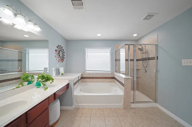 a spacious bathroom with a tub and shower