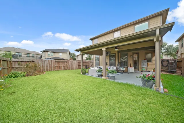 a view of a house with backyard porch and sitting area