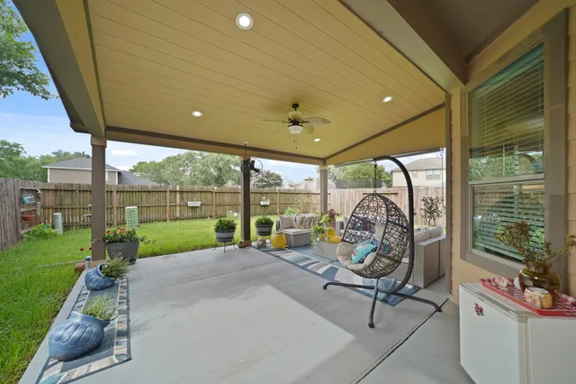 a view of a patio with a table chairs and a backyard
