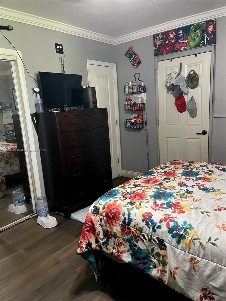 6221 Southwest 26th Street Miramar, FL 33023 - Photo 11 of 12 a bedroom with a bed dresser and a flat screen tv