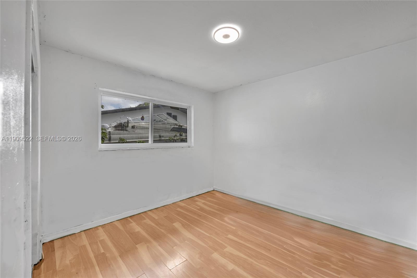 6221 Southwest 26th Street Miramar, FL 33023 - Photo 12 of 24 a view of empty room with wooden floor