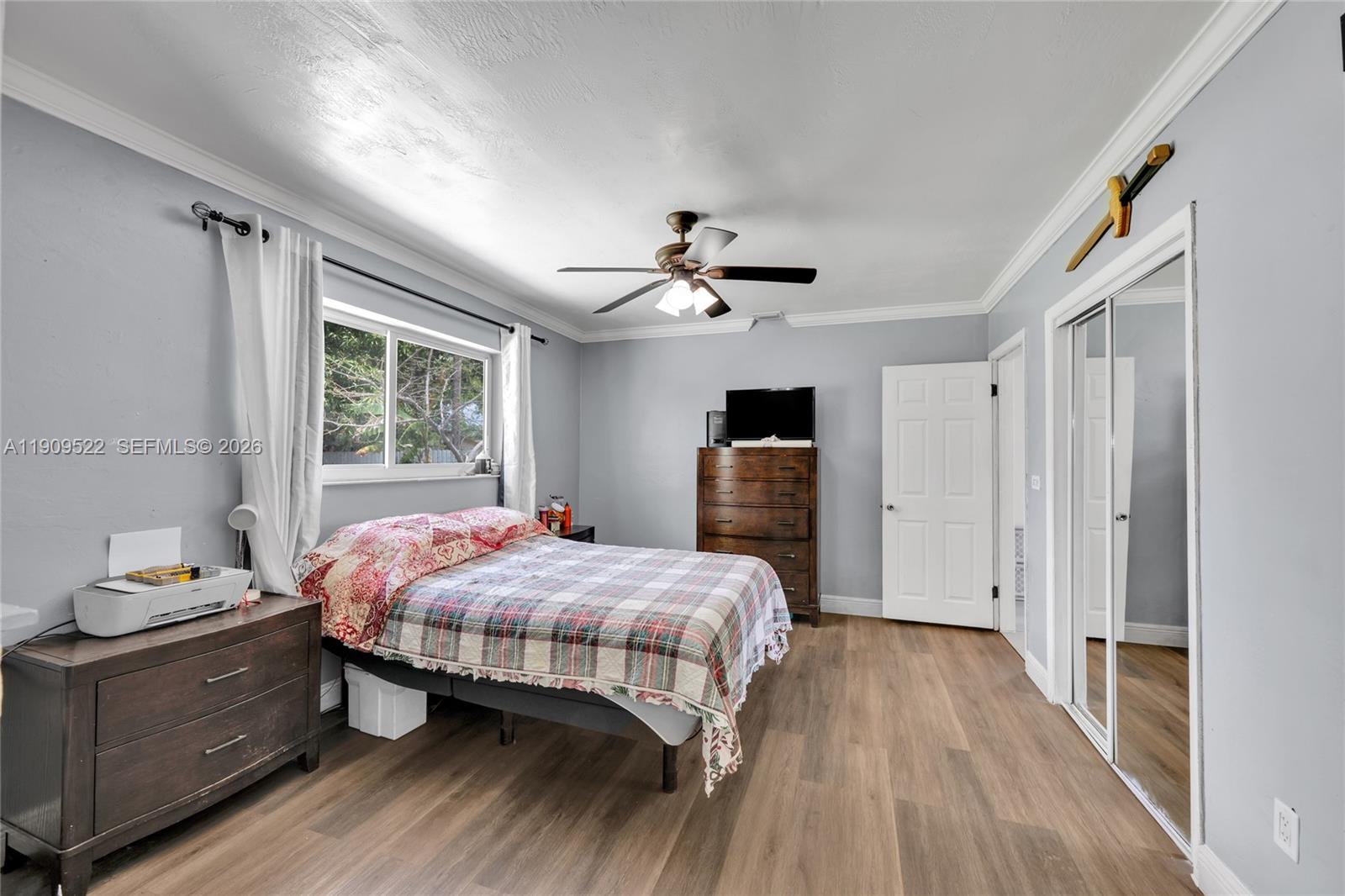 6221 Southwest 26th Street Miramar, FL 33023 - Photo 15 of 24 a bedroom with a bed and a chandelier
