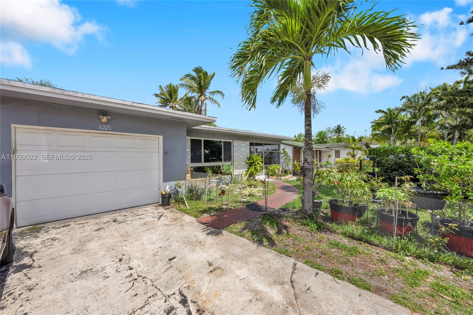 6221 Southwest 26th Street Miramar, FL 33023 - Photo 2 of 24 a front view of a house with garden