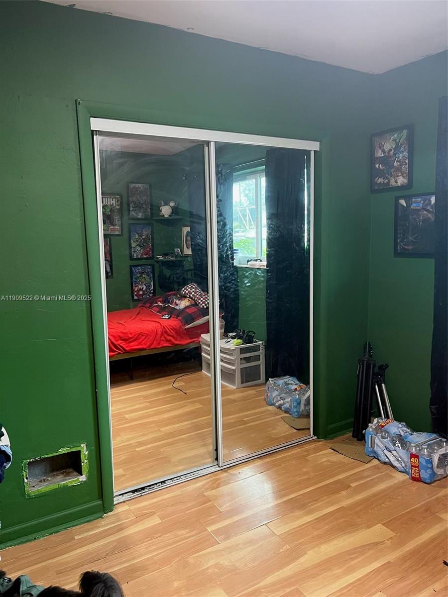 6221 Southwest 26th Street Miramar, FL 33023 - Photo 8 of 12 a bedroom with a bed and a window