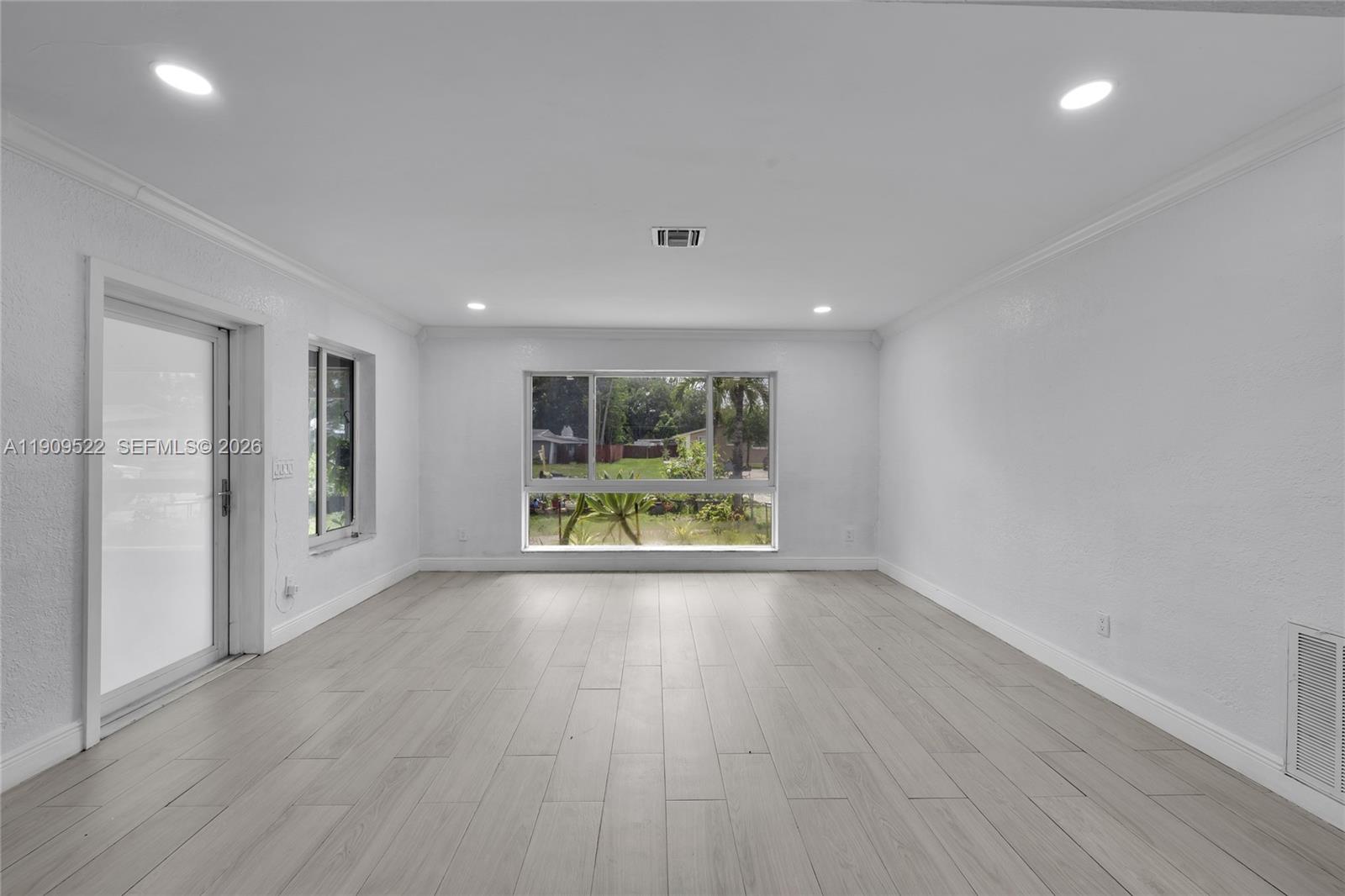 6221 Southwest 26th Street Miramar, FL 33023 - Photo 9 of 24 a view of an empty room with wooden floor