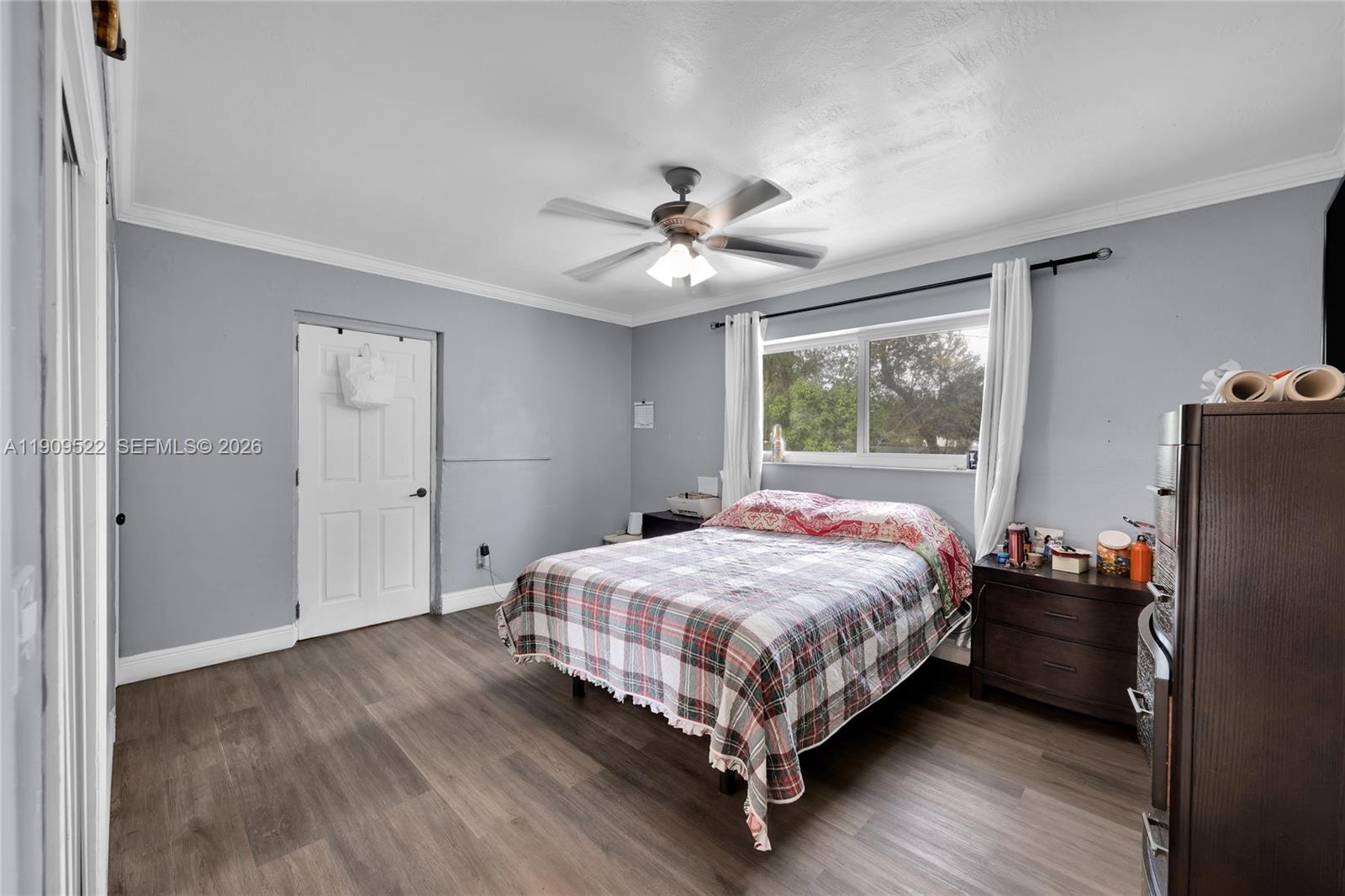 6221 Southwest 26th Street Miramar, FL 33023 - Photo 10 of 24 a bedroom with a bed and a chandelier
