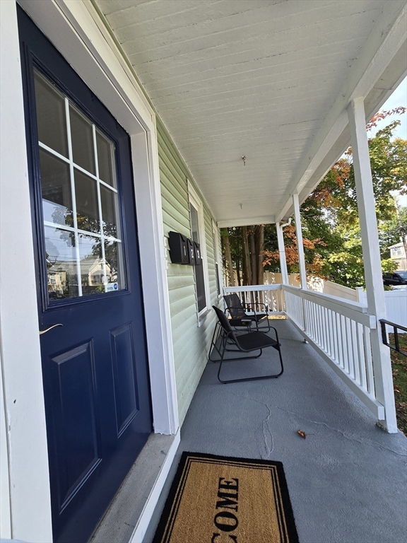 365 Whiting Avenue, Unit 2 Dedham, MA 02026 - Photo 3 of 15 a hallway with wooden floor and furniture