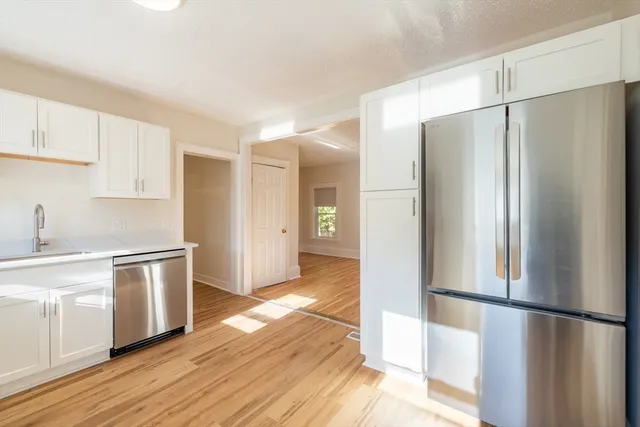 a kitchen with stainless steel appliances a refrigerator and a stove top oven