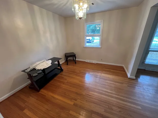 a living room with hard wood floors and a window
