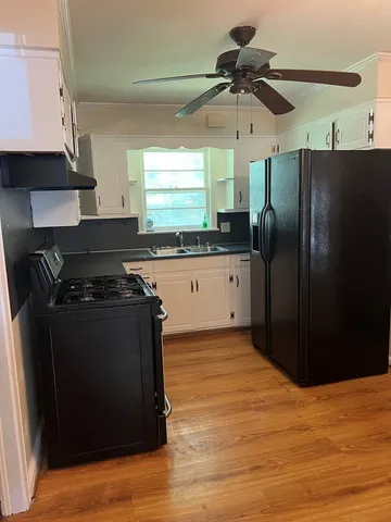 a kitchen with stainless steel appliances granite countertop a refrigerator and a sink