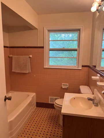 a bathroom with a sink a toilet and bathtub