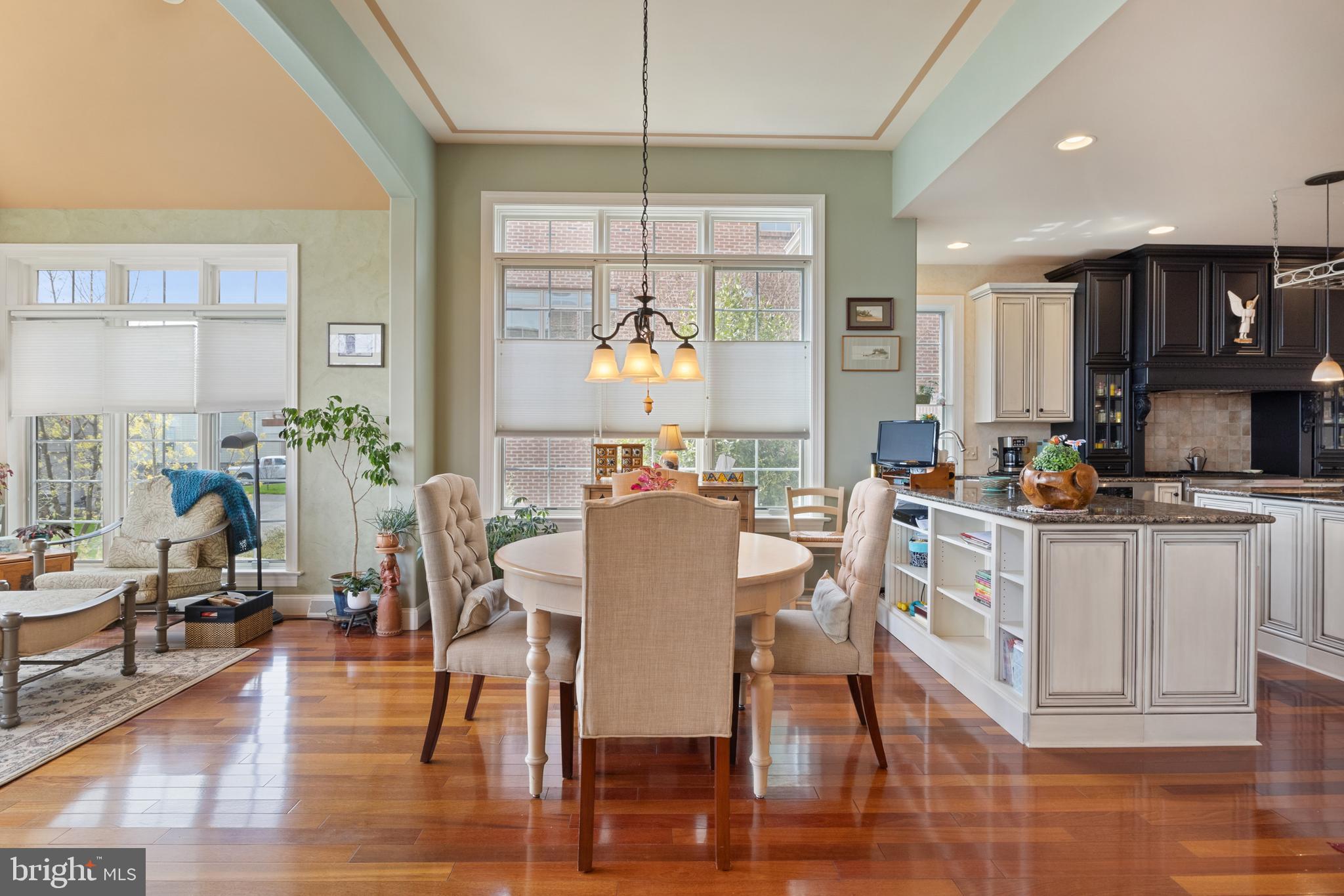 108 Valmere Path York, PA 17403 - Photo 15 of 84 a kitchen with stainless steel appliances granite countertop a stove a refrigerator a kitchen island a dining table and chairs with wooden floor