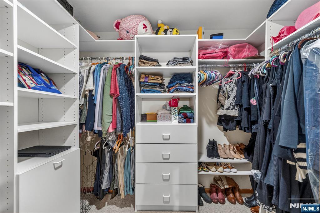 5110 Berkshire Valley Road Oak Ridge, NJ 07438 - Photo 27 of 49 a view of walk in closet with clothes and shoes