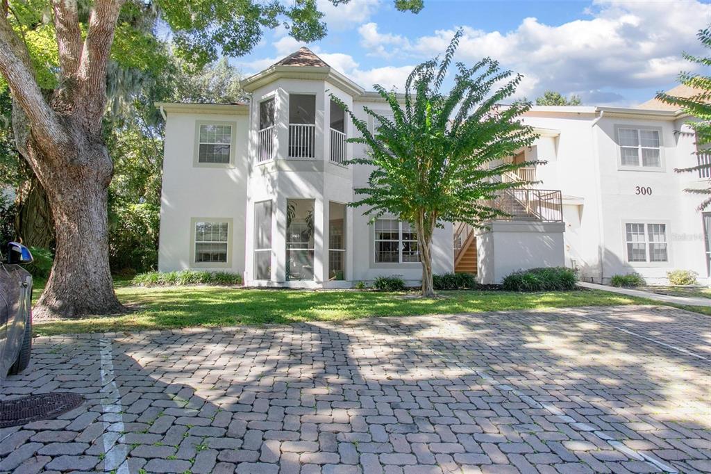 970 North Spring Garden Avenue, Unit 311 DeLand, FL 32720 - Photo 1 of 16 a front view of a house with a yard and trees