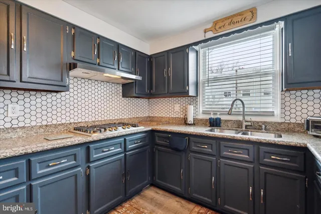 a kitchen with a sink and cabinets