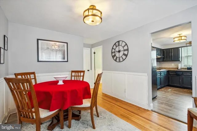 a view of a dining room with furniture and a chandelier