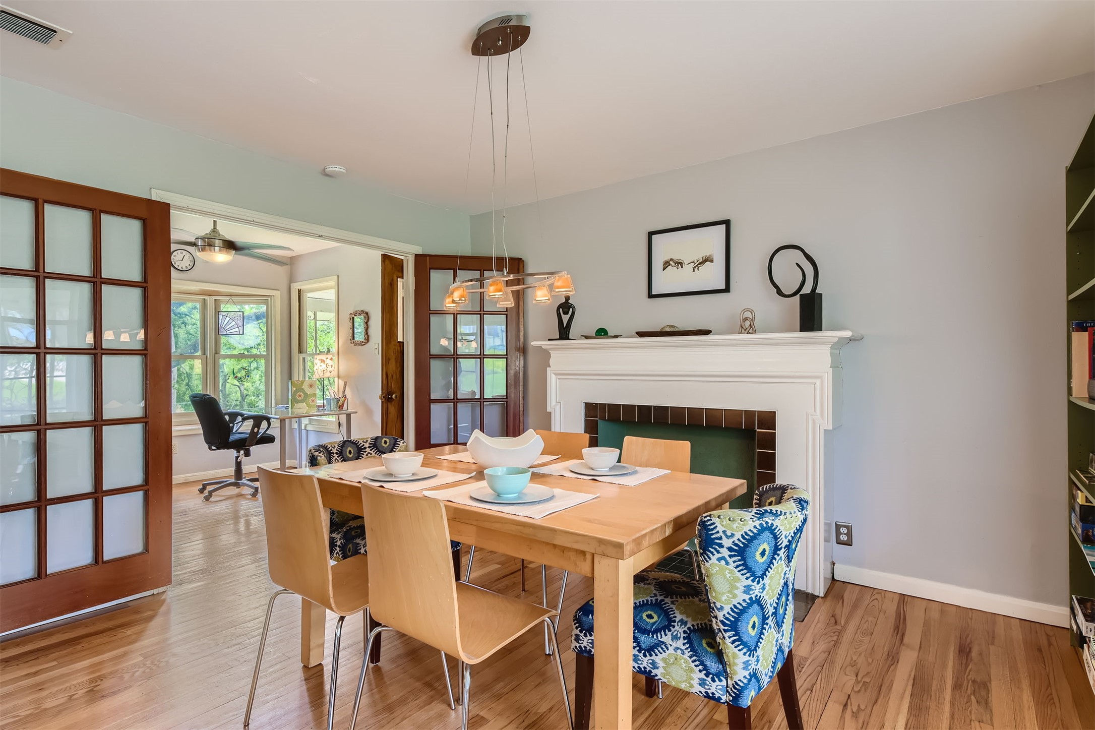 6804 Vine Street Austin, TX 78757 - Photo 4 of 15 a dining room with furniture a fireplace and wooden floor