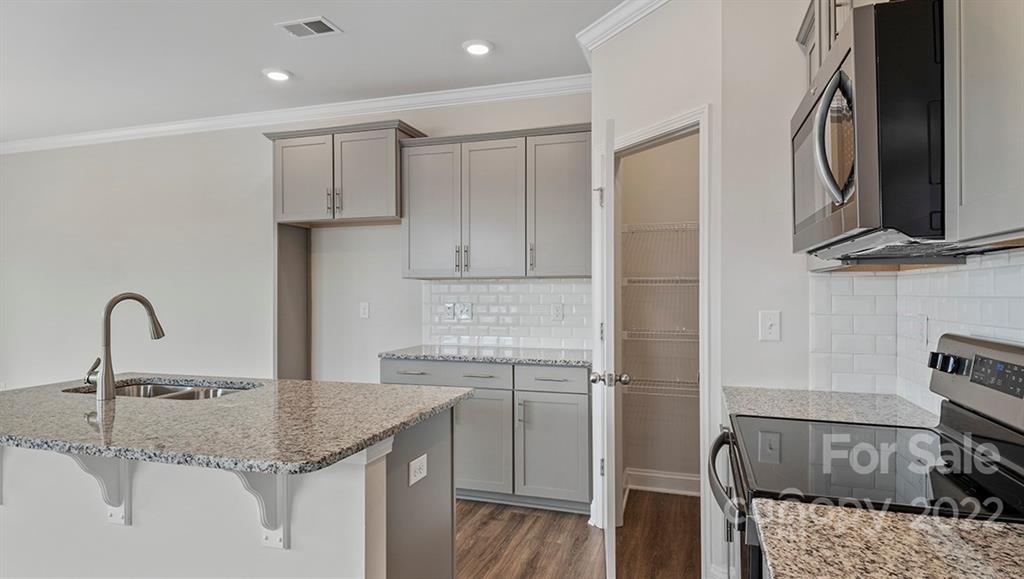 70 Creekview Road Hendersonville, NC 28792 - Photo 12 of 27 a kitchen with a sink and a refrigerator