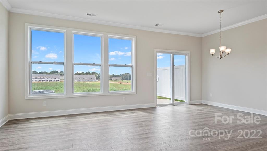 70 Creekview Road Hendersonville, NC 28792 - Photo 14 of 27 an empty room with wooden floor and windows