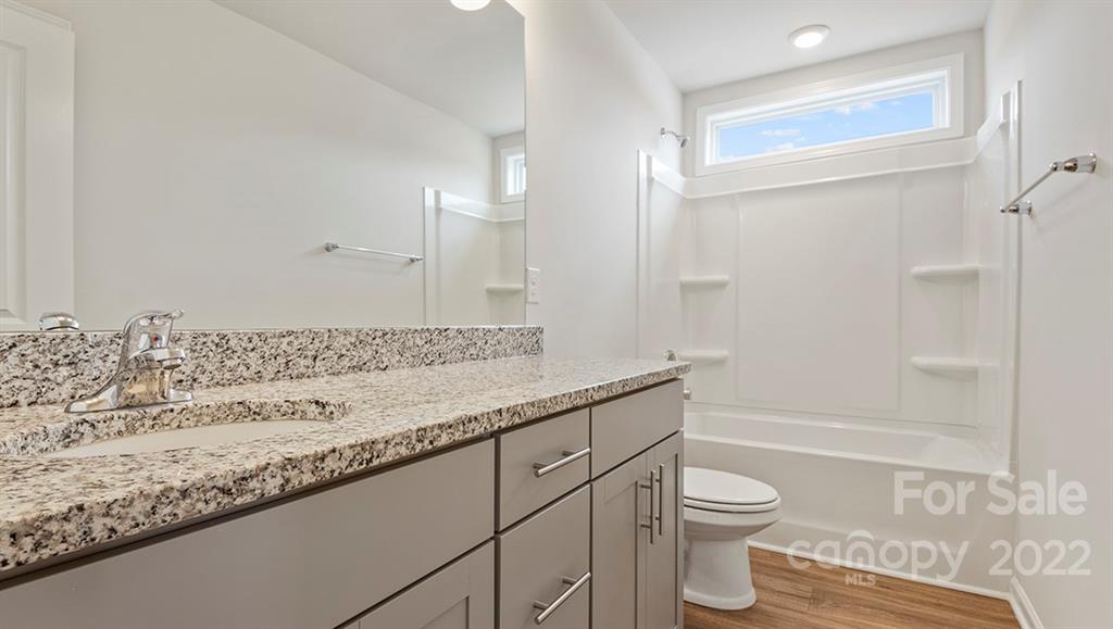 70 Creekview Road Hendersonville, NC 28792 - Photo 18 of 27 a bathroom with a granite countertop sink a toilet and shower