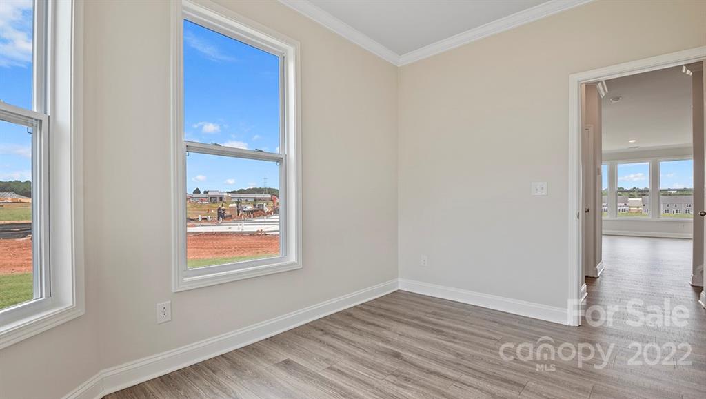 70 Creekview Road Hendersonville, NC 28792 - Photo 6 of 27 a view of an empty room with wooden floor and a window