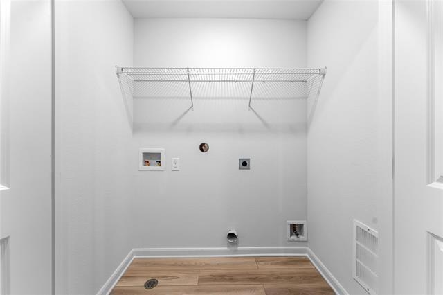 1226 Parker Drive Princeton, TX 75407 - Photo 13 of 35 Washroom featuring washer hookup, light wood-style floors, electric dryer hookup, and hookup for a gas dryer
