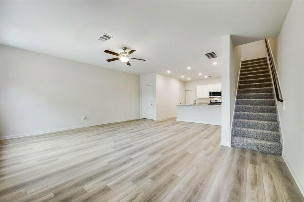1226 Parker Drive Princeton, TX 75407 - Photo 15 of 35 Unfurnished living room featuring recessed lighting, light wood-style floors, a ceiling fan, and stairway