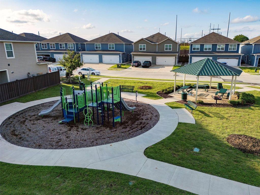 1226 Parker Drive Princeton, TX 75407 - Photo 29 of 35 Community playground featuring a residential view, a lawn, and a patio