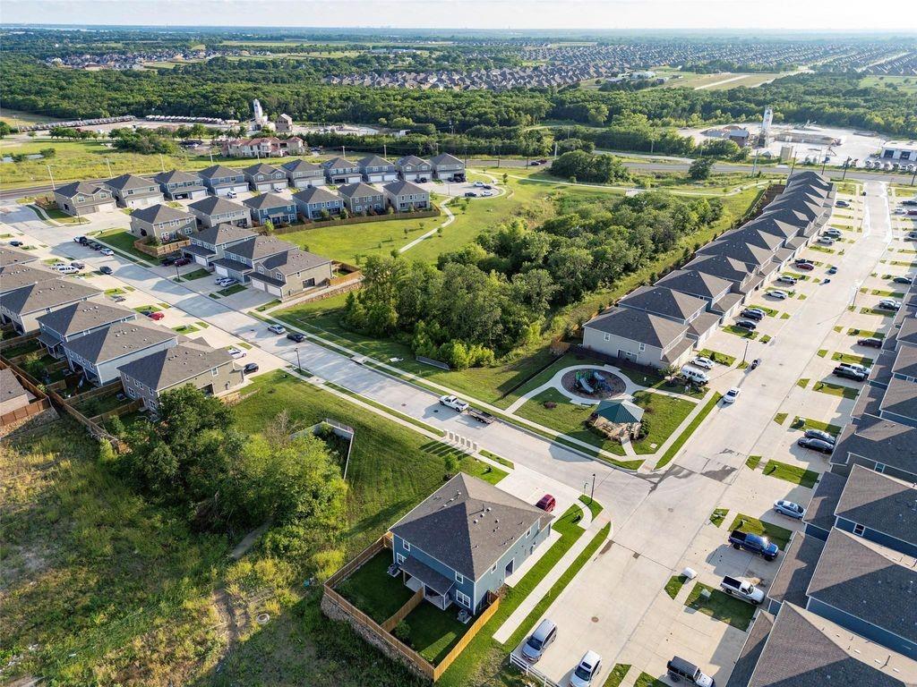 1226 Parker Drive Princeton, TX 75407 - Photo 34 of 35 Aerial overview of property's location with nearby suburban area and a tree filled landscape