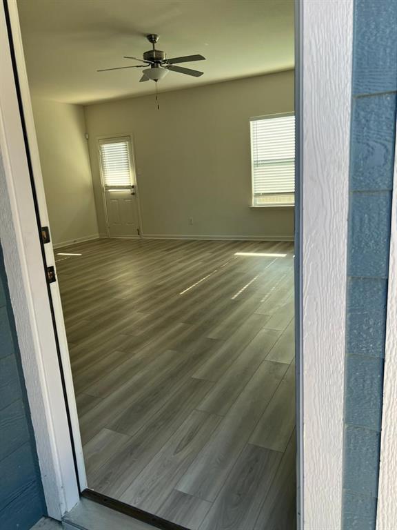 1226 Parker Drive Princeton, TX 75407 - Photo 9 of 35 Empty room featuring wood finished floors and ceiling fan