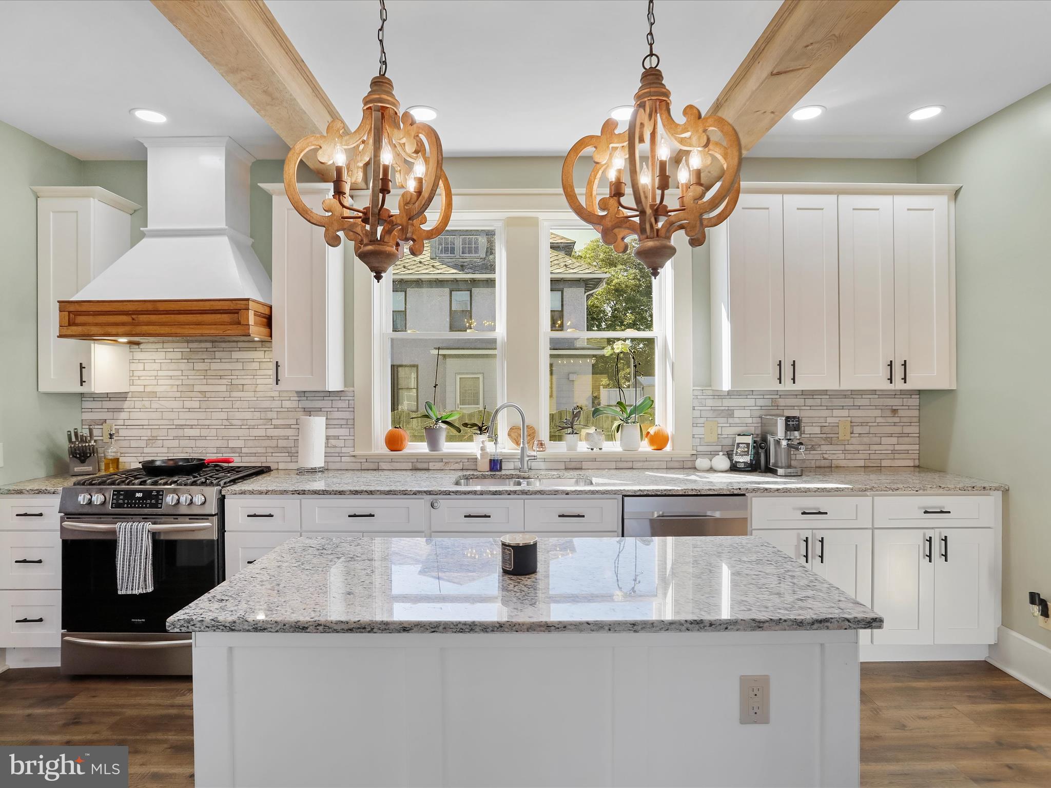 504 Prince George Street Cumberland, MD 21502 - Photo 12 of 33 a kitchen with stainless steel appliances granite countertop a sink a stove and a wooden floors