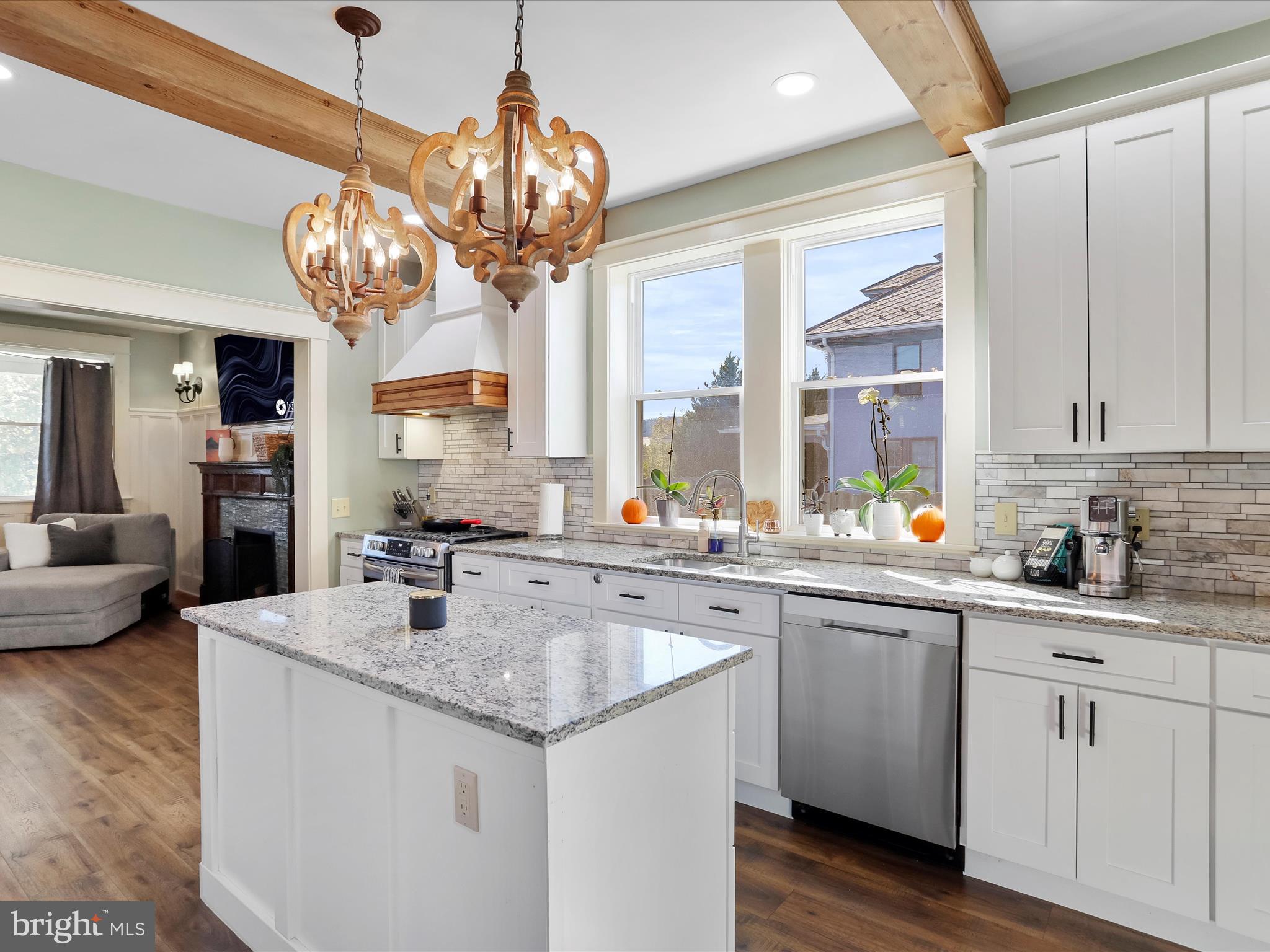 504 Prince George Street Cumberland, MD 21502 - Photo 15 of 33 a kitchen with a sink a chandelier and living room view