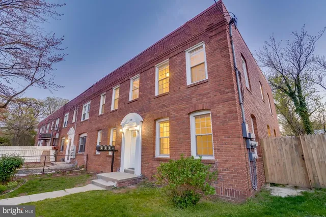 a view of a brick building with a yard