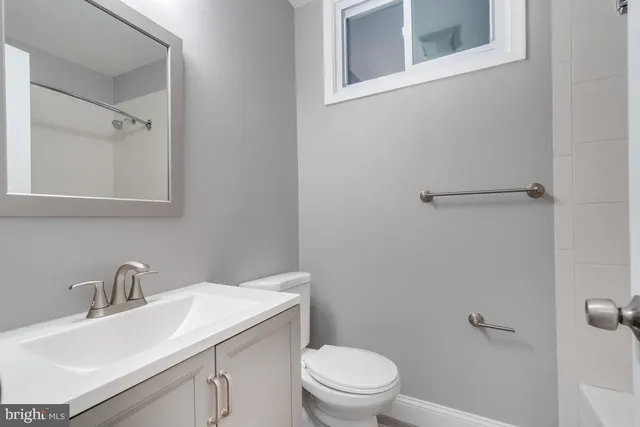 a bathroom with a sink toilet and vanity