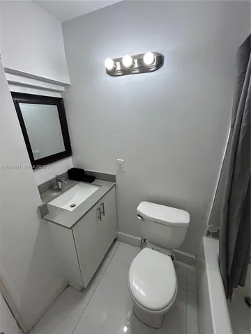 a bathroom with a toilet a sink and a mirror