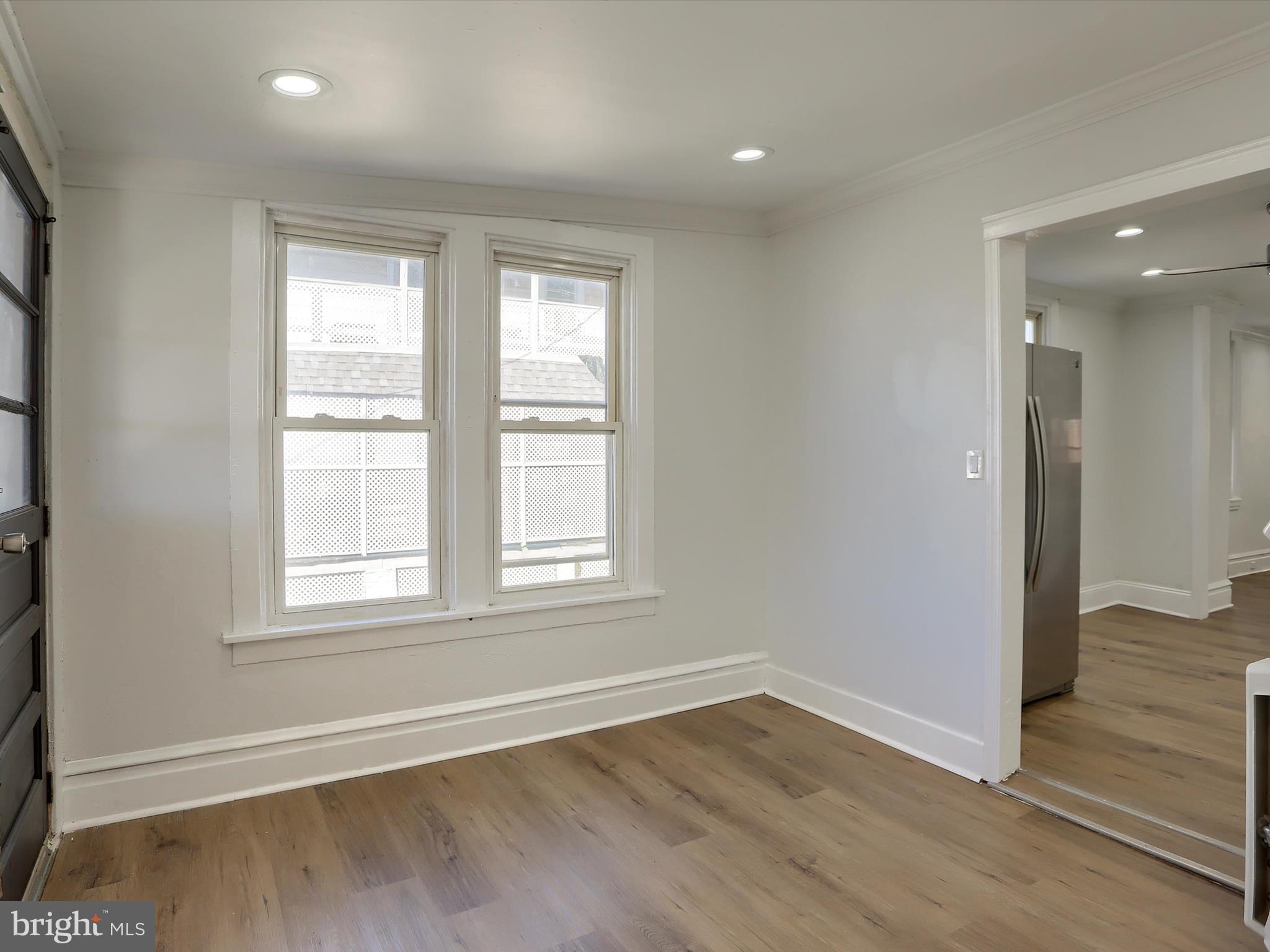556 North 2nd Street Steelton, PA 17113 - Photo 15 of 33 an empty room with wooden floor and windows