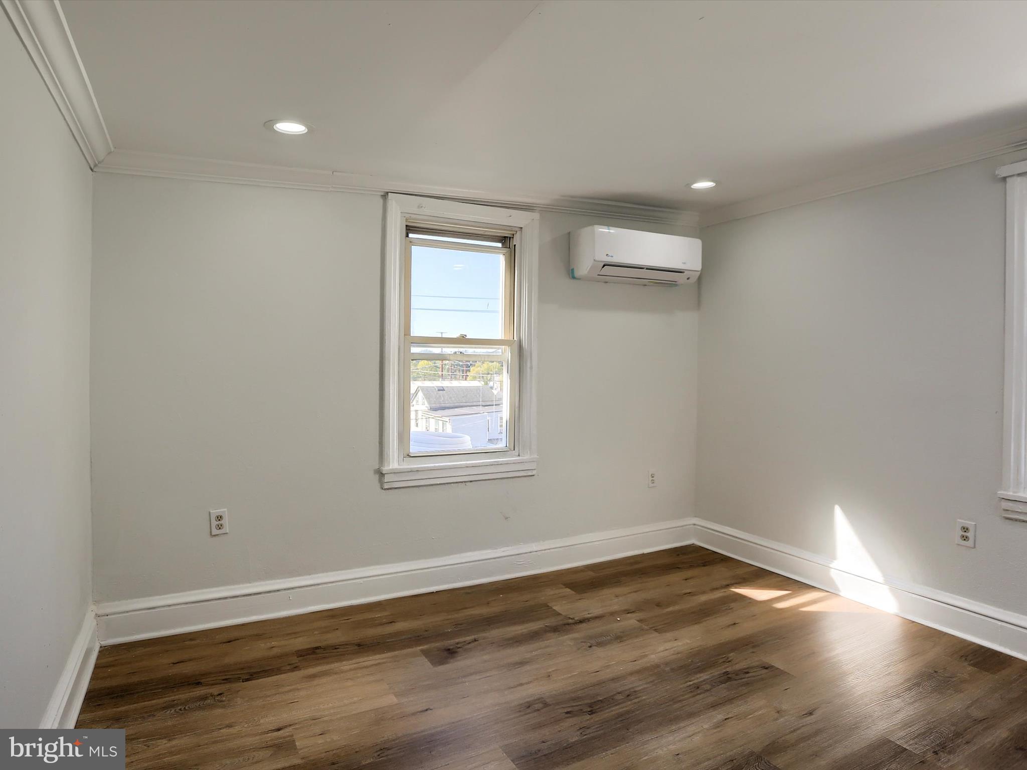 556 North 2nd Street Steelton, PA 17113 - Photo 18 of 33 an empty room with wooden floor and windows