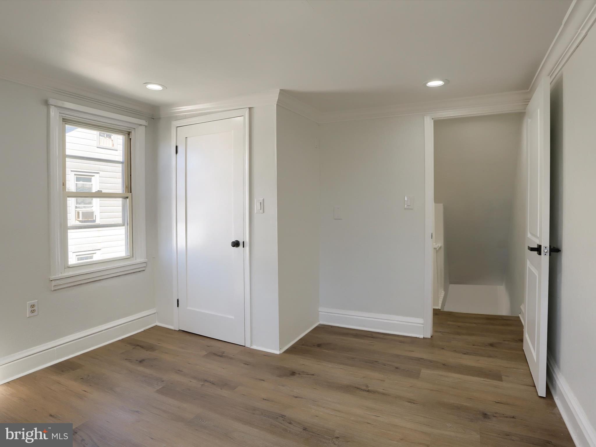 556 North 2nd Street Steelton, PA 17113 - Photo 19 of 33 a view of an empty room with wooden floor and a window