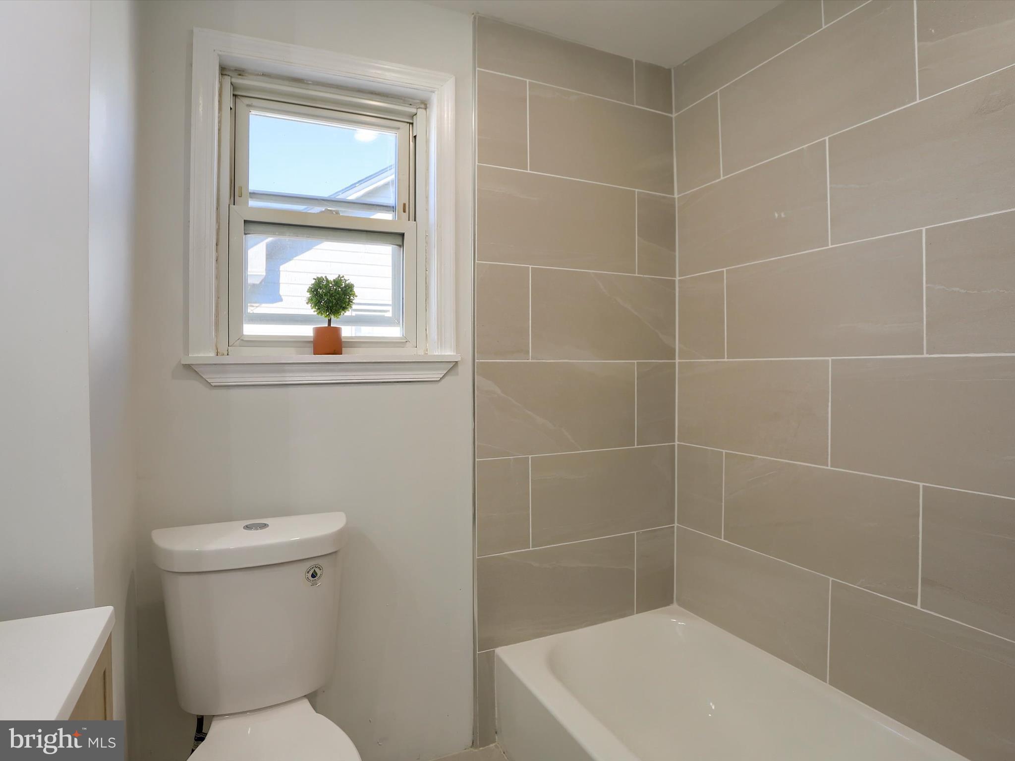 556 North 2nd Street Steelton, PA 17113 - Photo 22 of 33 a bathroom with a toilet a window and shower