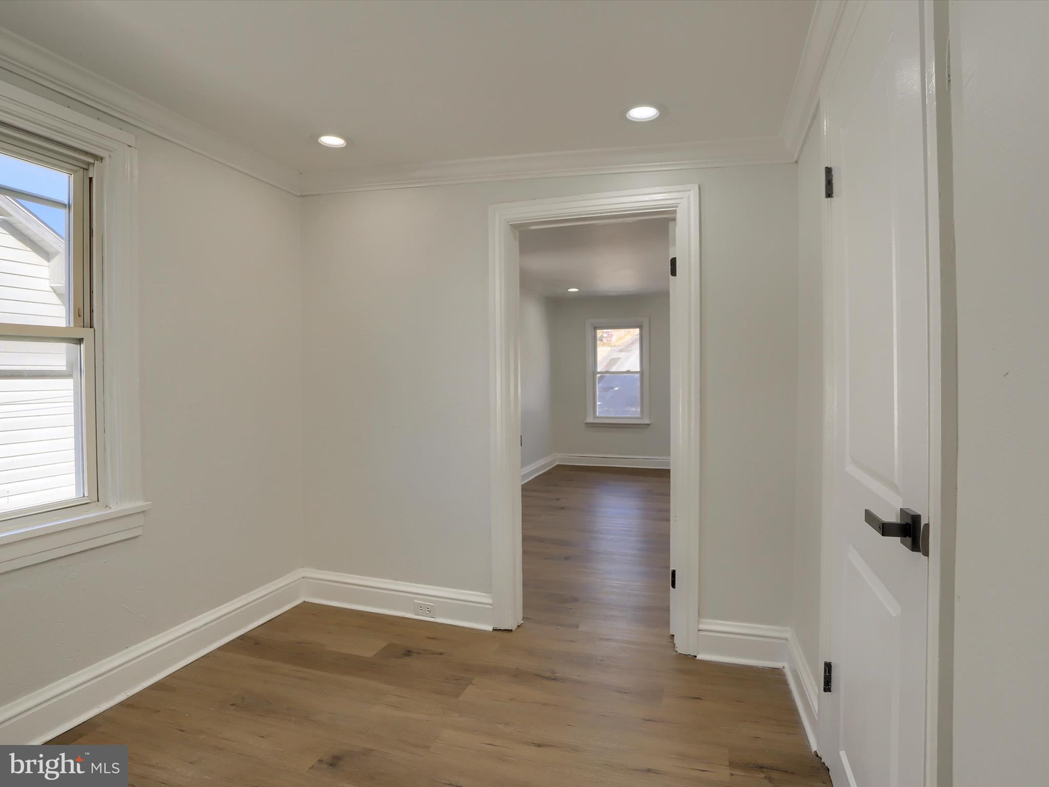 556 North 2nd Street Steelton, PA 17113 - Photo 23 of 33 an empty room with wooden floor and windows