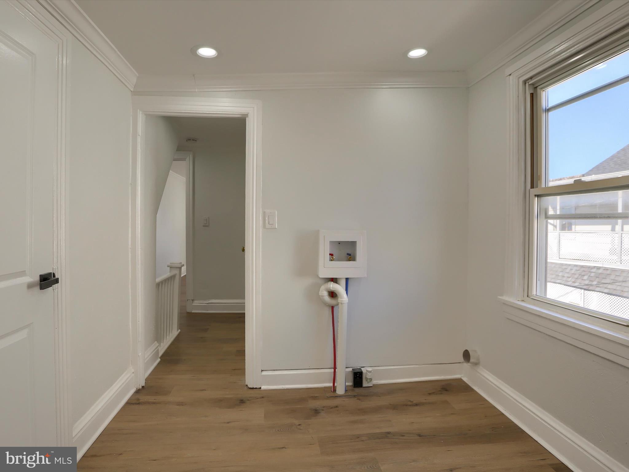 556 North 2nd Street Steelton, PA 17113 - Photo 24 of 33 an empty room with wooden floor and a window
